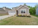 Attractive home featuring a two-car garage and a well-maintained front yard, complemented by brick accents at 179 Bezelle Ave # 34, York, SC 29745