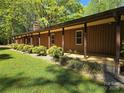 Long, covered porch showcasing wood siding, manicured hedges, and a lush lawn at 1855 7Th St, Salisbury, NC 28144