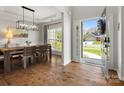 Elegant dining room features wood floors, modern chandelier, and natural light from front door view at 2002 Potomac Rd, Indian Trail, NC 28079