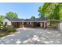 Brick home with a covered carport, bench seating, and well-kept landscaping, offering a welcoming and practical design at 319 Hatley Ne Cir, Concord, NC 28025