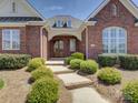 Inviting brick home with a double-door entryway and landscaped garden at 324 Quinby Way, Rock Hill, SC 29732
