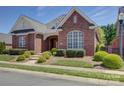 Beautiful brick home featuring manicured landscaping and a stone walkway at 324 Quinby Way, Rock Hill, SC 29732