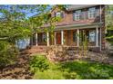 Inviting brick home with a covered porch, classic shutters, and well-maintained landscaping at 422 Wildwood Dr, Salisbury, NC 28146