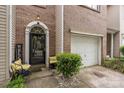 Charming brick townhome features a black front door and a one car garage at 5310 Glenlea Walk Ln, Charlotte, NC 28216