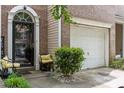 Exterior view of a charming brick townhome with front door and one car garage at 5310 Glenlea Walk Ln, Charlotte, NC 28216