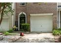 Charming brick townhome features a black front door and a one car garage at 5310 Glenlea Walk Ln, Charlotte, NC 28216
