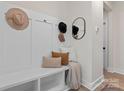 Inviting entryway with a custom-built mudroom bench and storage for organized living at 706 Falling Oak Aly # 16, Huntersville, NC 28078