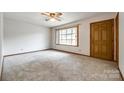 Bright living room featuring carpet flooring, a large window, and a classic ceiling fan at 862 Eastwood Dr, Rock Hill, SC 29730