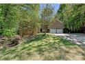 Brick house with a two-car garage, driveway, and lawn surrounded by mature trees providing shade at 9600 Lockhorn Ct, Mint Hill, NC 28227