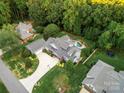 Aerial view of a beautiful home with a pool, lush landscaping, and ample yard space at 1068 Grant Dr, Denver, NC 28037