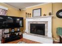 Close up of a fireplace with black trim, tile detail and mantel decorations at 111 Peoria Ln, Kings Mountain, NC 28086