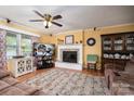 Cozy living room with a fireplace, ceiling fan, and comfortable brown recliner at 111 Peoria Ln, Kings Mountain, NC 28086