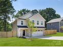 Well-maintained two-story home with a fresh lawn and a privacy fence, perfect for outdoor enjoyment at 1141 Thayer Glen Ct, Charlotte, NC 28213