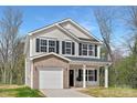 Charming two-story home with light siding, black shutters, and a cozy front porch at 1144 Thayer Glen Ct, Charlotte, NC 28213