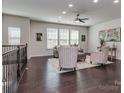Spacious living area boasts hardwood floors, a ceiling fan, and lots of natural light at 12214 Ardrey Park Dr, Charlotte, NC 28277