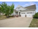Beautiful home with a welcoming entrance, two-car garage, and a spacious driveway at 13115 Union Square Dr, Huntersville, NC 28078