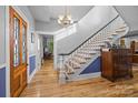 Grand foyer with beautiful hardwood floors, staircase, and elegant chandelier lighting at 1321 South Point Rd, Belmont, NC 28012