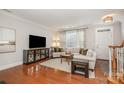 Inviting living room with hardwood floors, decorative cabinet, and a large window at 14457 Adair Manor Ct, Charlotte, NC 28277