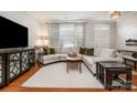 Inviting living room with hardwood floors, decorative cabinet, and a large window at 14457 Adair Manor Ct, Charlotte, NC 28277