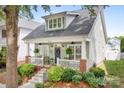 Beautiful home showcasing a lovely front porch with seating, manicured landscaping, and inviting curb appeal at 14541 Holly Springs Dr, Huntersville, NC 28078