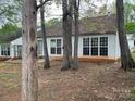 A view of the backyard, showcasing mature trees and a patio area at 1507 Rumstone Ln, Charlotte, NC 28262