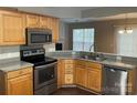 Kitchen featuring wooden cabinets, stainless steel appliances, and a granite countertop at 1507 Rumstone Ln, Charlotte, NC 28262