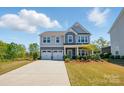 Beautiful two-story home with a two-car garage, covered porch, and lush, well-maintained lawn at 1578 Whitman Ct, York, SC 29745