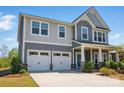 Attractive two-story home featuring a two-car garage, inviting front porch and professionally landscaped lawn at 1578 Whitman Ct, York, SC 29745
