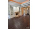 Spacious living room showcases hardwood floors, fireplace, and classic columns at 17408 Summer Place Dr, Cornelius, NC 28031