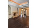 Elegant living room features a stone fireplace and built-in shelving at 17408 Summer Place Dr, Cornelius, NC 28031