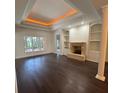 Bright living room boasts a cozy fireplace, built-in bookshelves, and hardwood floors at 17408 Summer Place Dr, Cornelius, NC 28031