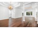 Spacious living room with hardwood floors, elegant chandelier, and bright natural light at 17408 Summer Place Dr, Cornelius, NC 28031