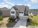 Aerial view of a lovely two-story home with manicured lawn and beautiful landscaping at 17502 Snug Harbor Rd, Charlotte, NC 28278