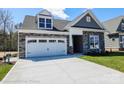 Beautiful single-Gathering home with stone accents, lush green lawn, and an attached two-car garage at 2007 Mantle Ridge Dr # 192, Indian Trail, NC 28079