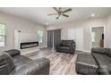 Spacious living room with an electric fireplace, ceiling fan, and gray leather furnishings at 209 Sheffield Dr, York, SC 29745