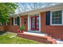 Inviting front entrance featuring bright red double doors and classic brick accents at 218 N Bost St, Statesville, NC 28677