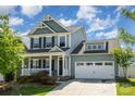 Charming two-story home with a welcoming front porch and a spacious two-car garage at 4406 Huntley Glen Dr, Pineville, NC 28134