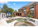 Luxury pool area with lounge chairs, manicured garden, and an elegant pergola at 4465 3Rd Nw St, Hickory, NC 28601