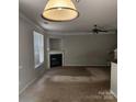 Spacious living room with a cozy fireplace, neutral carpet, and ample natural light at 616 Mountain Quail Dr, Charlotte, NC 28216