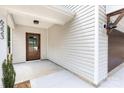 Inviting entryway featuring a wood-look door, modern lighting, and a charming exterior at 6223 Rockwell W Blvd, Charlotte, NC 28269