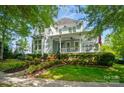 Charming two-story home with a welcoming front porch and beautifully landscaped front yard at 648 Revival Row, Fort Mill, SC 29708