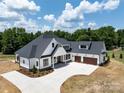 Expansive aerial view of a stunning farmhouse with a long driveway and lush greenery at 6511 Rehobeth Rd, Waxhaw, NC 28173