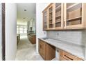 A kitchen area features wood cabinets, drawers, shelving, a sink, and gray marbled countertops at 6511 Rehobeth Rd, Waxhaw, NC 28173