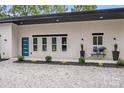 Eye-catching modern home featuring a blue entry door and manicured landscape at 6907 Lancaster Hwy, Waxhaw, NC 28173
