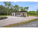 Exterior view of a modern single story home with a gravel driveway at 6907 Lancaster Hwy, Waxhaw, NC 28173