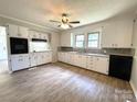Bright kitchen featuring sleek countertops, white cabinetry, and modern appliances at 717 Wilshire Sw Ave, Concord, NC 28025