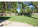 Expansive backyard with a well-kept lawn, mature trees, and shed at 920 Squirrel Hill Rd, Charlotte, NC 28213
