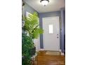 A welcoming foyer with hardwood floors, soft gray walls, and a charming 'HOME' doormat at 920 Squirrel Hill Rd, Charlotte, NC 28213
