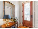 Elegant foyer featuring hardwood floors, decorative door, table and stylish mirror at 962 Blakeley Walk, Rock Hill, SC 29732