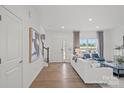 Bright living room boasts hardwood floors, neutral decor, and a view of the outdoors at 10033 Guardian Dr # 265, Charlotte, NC 28273